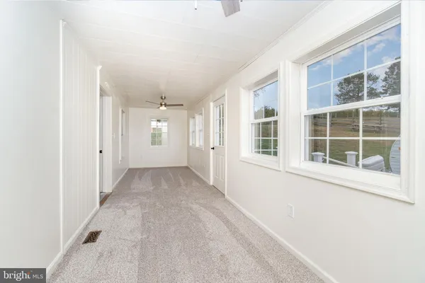 an empty room with a empty space and windows