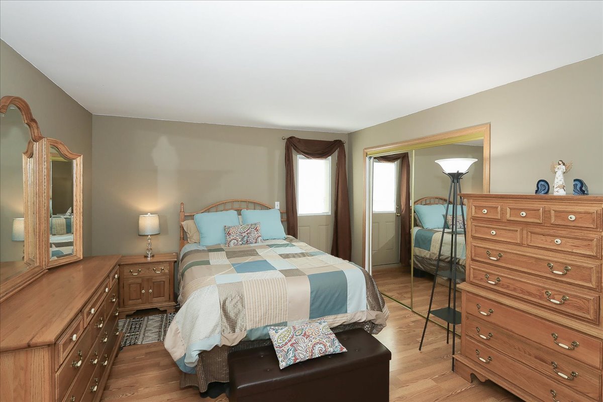 760 Checker Drive Buffalo Grove, IL 60089 - Photo 11 of 29 a bedroom with a bed and a dresser