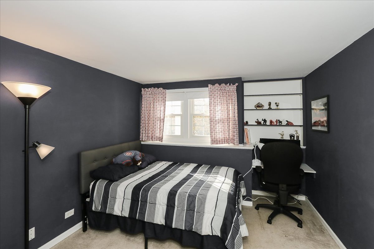 760 Checker Drive Buffalo Grove, IL 60089 - Photo 22 of 29 a bedroom with a bed and a window