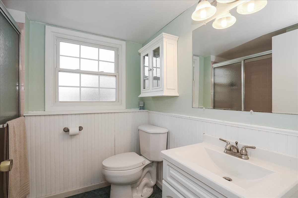 760 Checker Drive Buffalo Grove, IL 60089 - Photo 23 of 29 a bathroom with a sink a toilet and a mirror