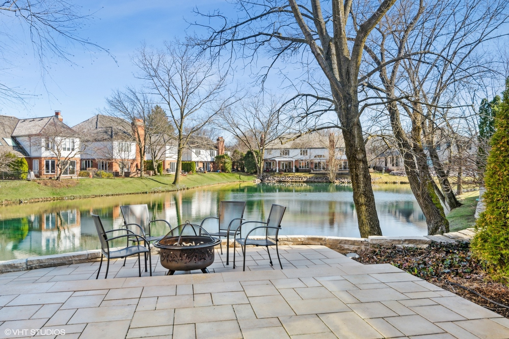 1049 Mar Ln Drive Lake Forest, IL 60045 - Photo 2 of 25 a view of a lake with a bench and trees around
