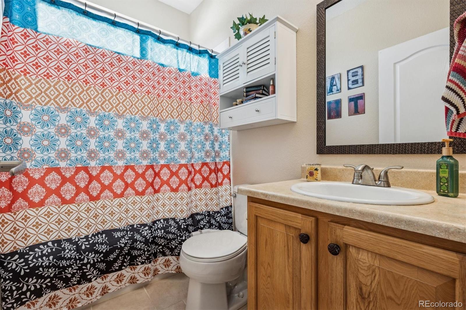 10822 Glengate Circle Highlands Ranch, CO 80130 - Photo 12 of 47 a bathroom with a sink toilet and a shower