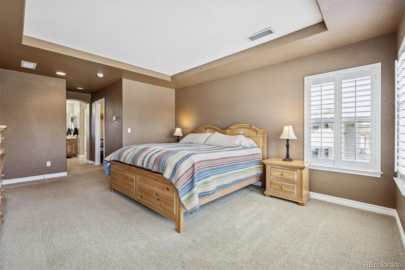 10822 Glengate Circle Highlands Ranch, CO 80130 - Photo 17 of 47 a bedroom with a bed and a window