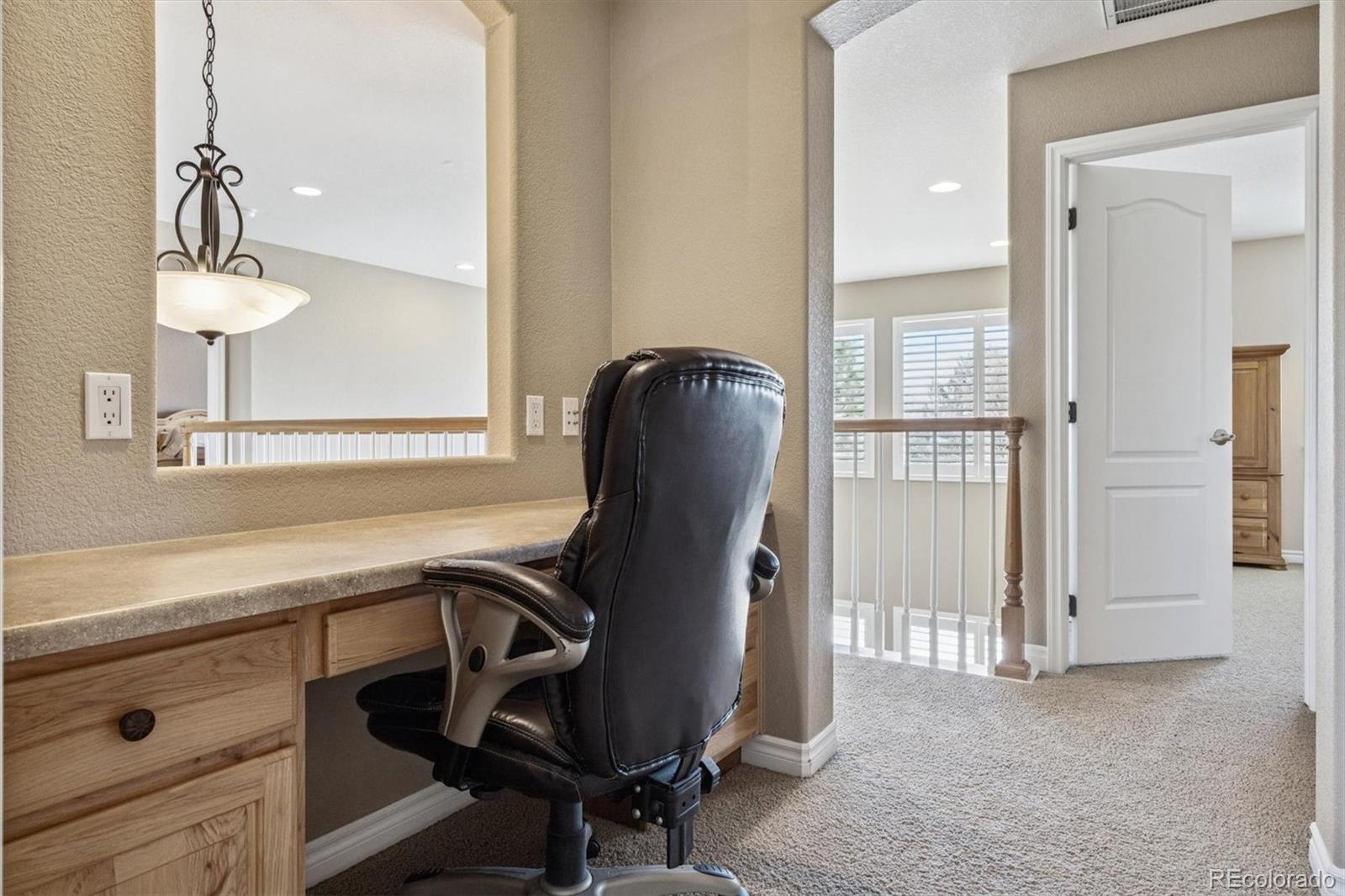 10822 Glengate Circle Highlands Ranch, CO 80130 - Photo 21 of 47 a view of a workspace room with wooden floor and windows
