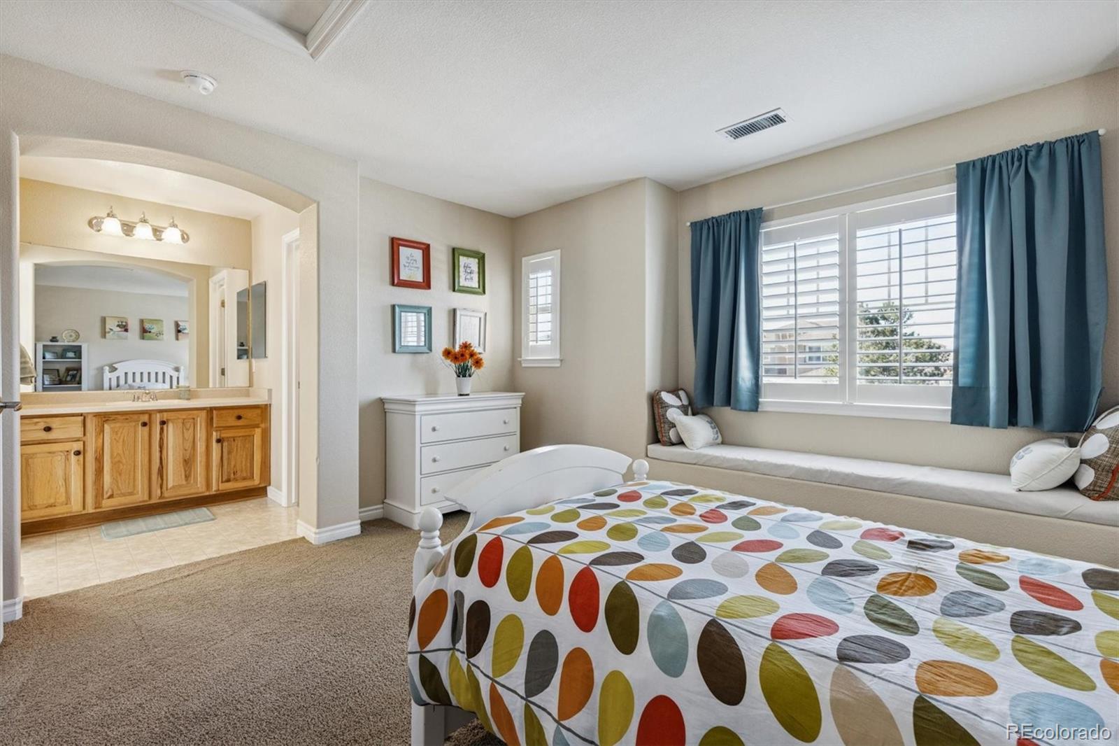 10822 Glengate Circle Highlands Ranch, CO 80130 - Photo 23 of 47 a bedroom with a bed and a cabinets