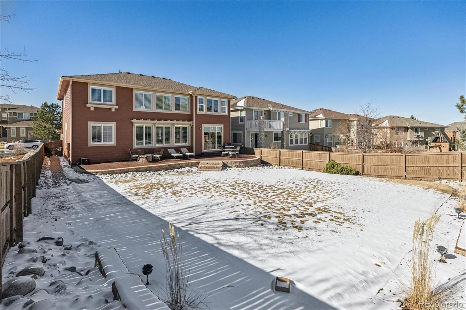 10822 Glengate Circle Highlands Ranch, CO 80130 - Photo 36 of 47 a view of a yard with a bench in the patio