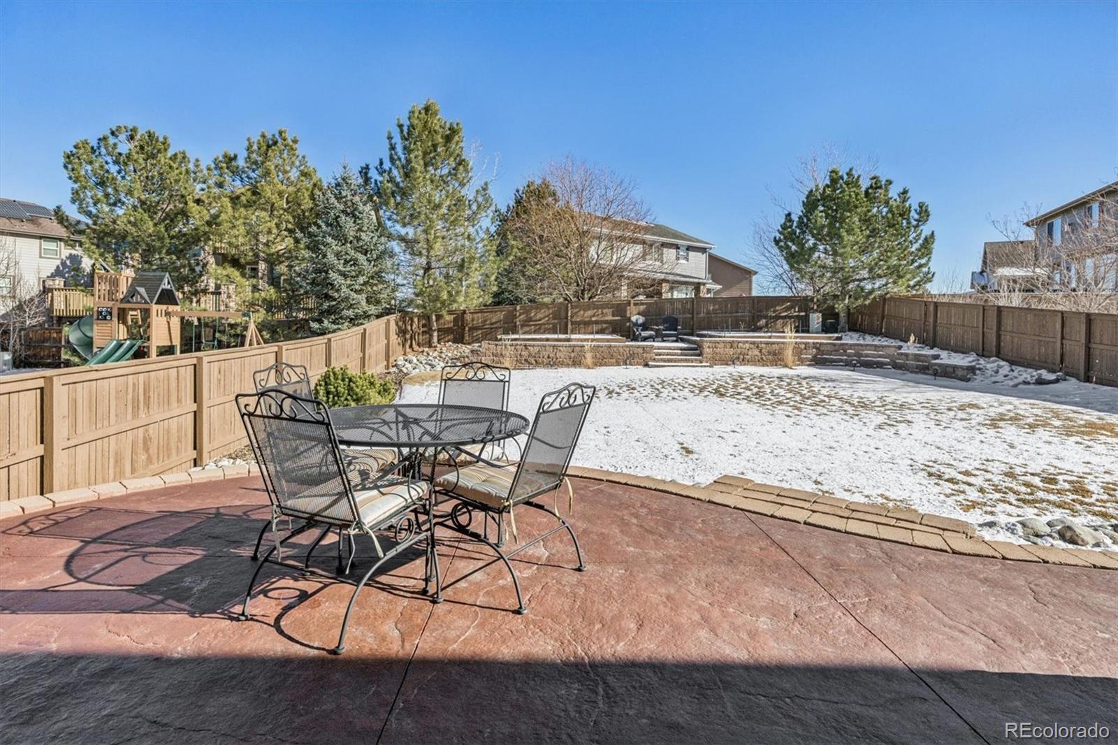 10822 Glengate Circle Highlands Ranch, CO 80130 - Photo 40 of 47 a view of a backyard house with table and chairs