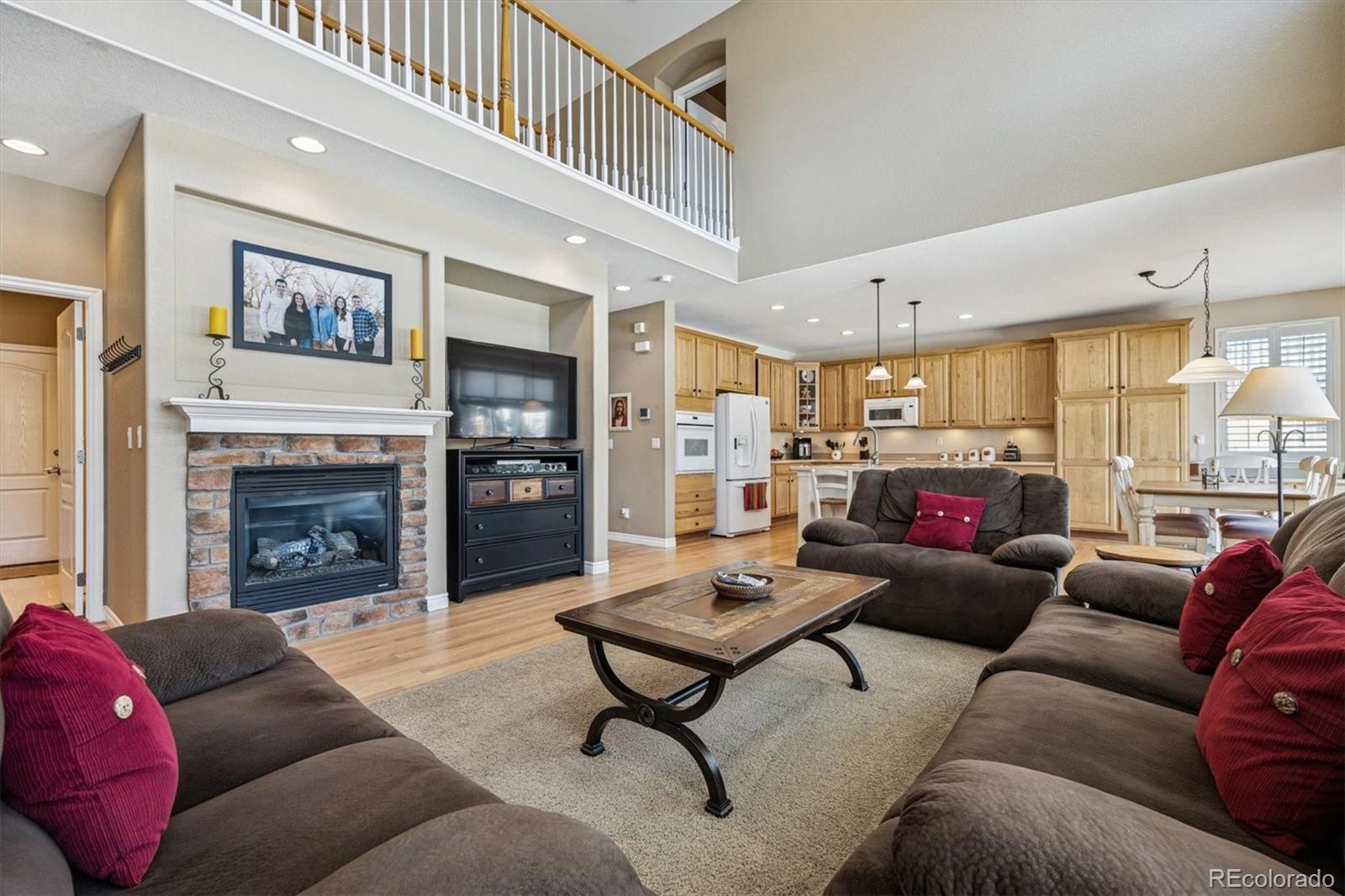 10822 Glengate Circle Highlands Ranch, CO 80130 - Photo 4 of 47 a living room with furniture a fireplace and a large window