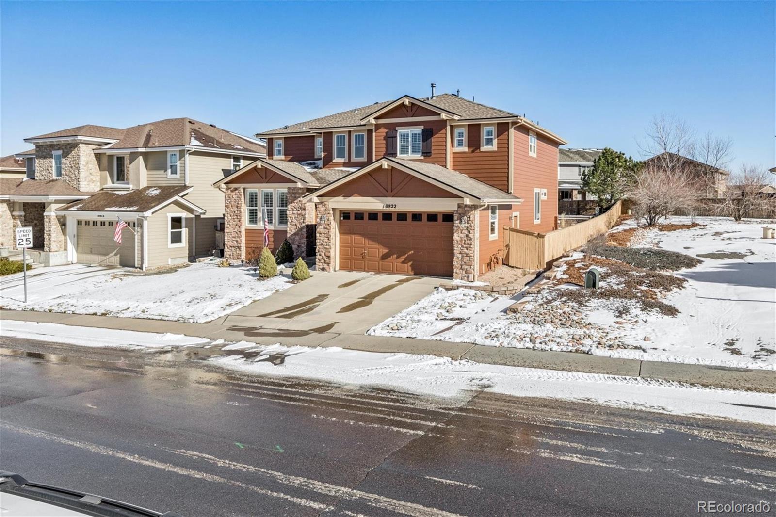 10822 Glengate Circle Highlands Ranch, CO 80130 - Photo 42 of 47 a front view of a house with a yard