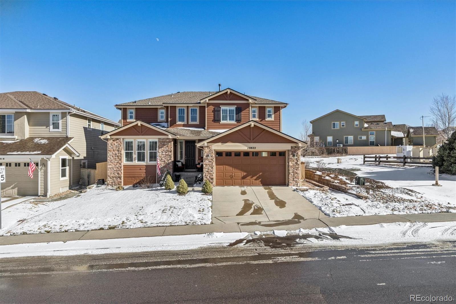 10822 Glengate Circle Highlands Ranch, CO 80130 - Photo 43 of 47 a front view of a house with a yard