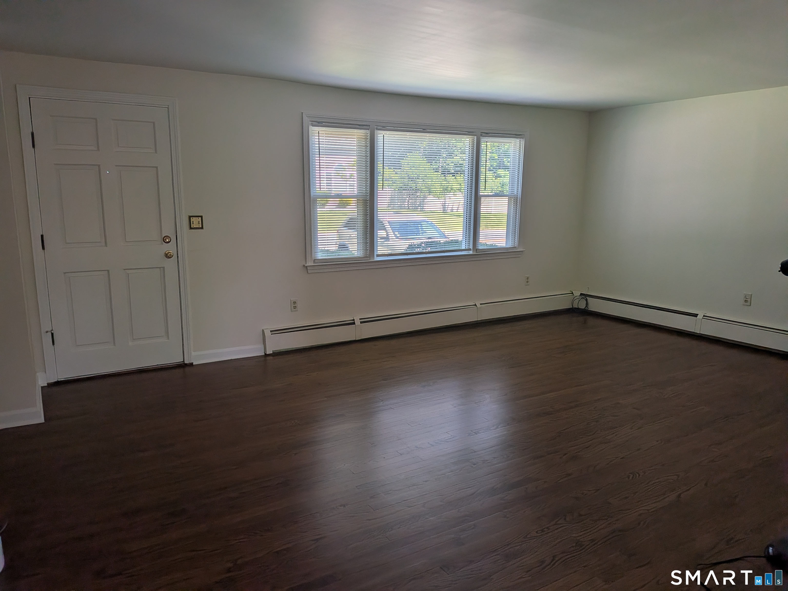 124 Spring Lake Road Waterbury, CT 06706 - Photo 2 of 34 Living room interior view of front door taken from the large kitchen.