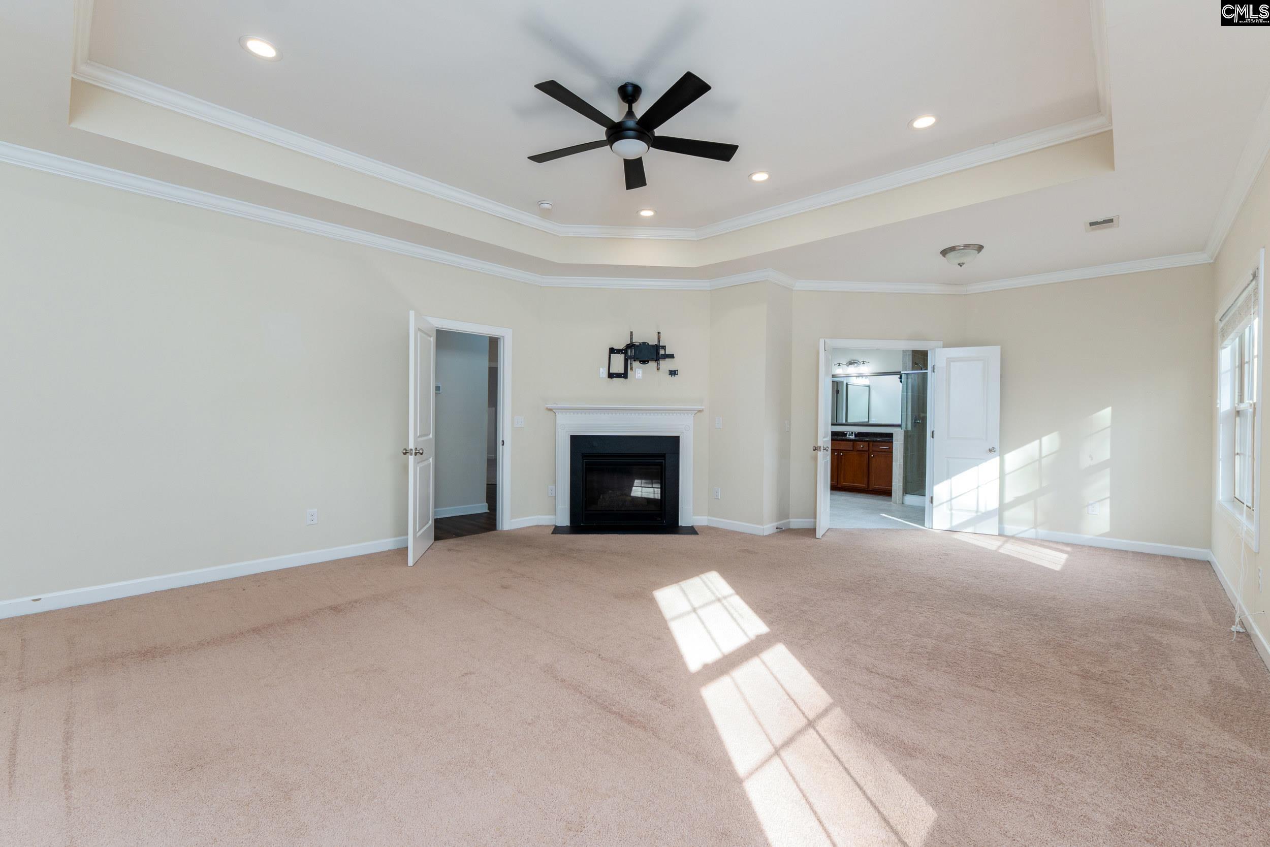 40 Wading Bird Loop Blythewood, SC 29016 - Photo 10 of 26 a view of a livingroom with a fireplace and a chandelier fan