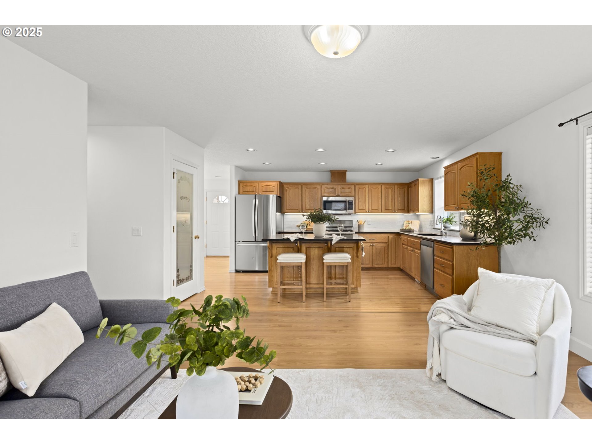 22271 Northeast Lachenview Lane Fairview, OR 97024 - Photo 16 of 40 a living room with furniture dining table and a view of kitchen