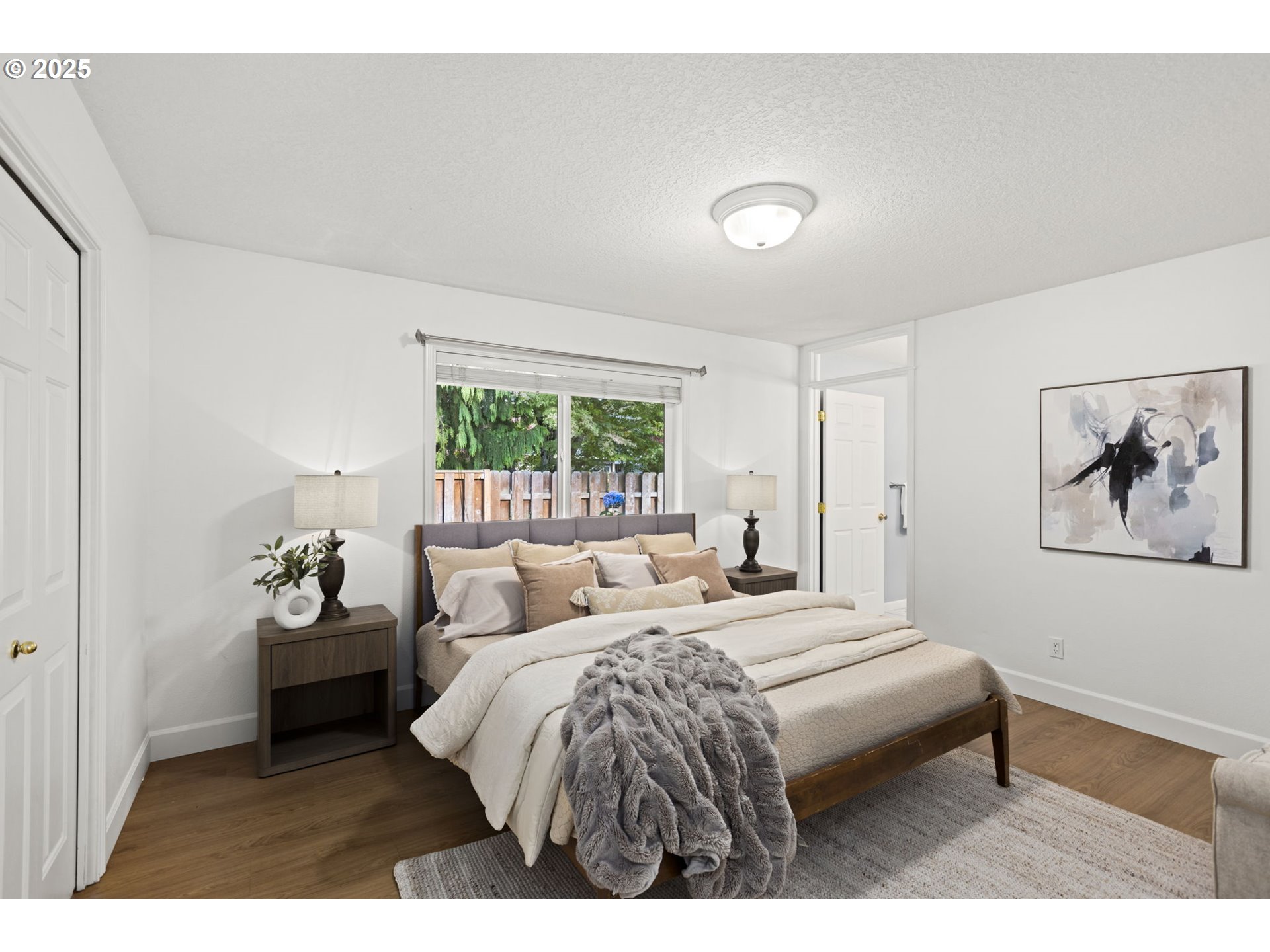 22271 Northeast Lachenview Lane Fairview, OR 97024 - Photo 17 of 40 a bedroom with a bed and a painting on the wall