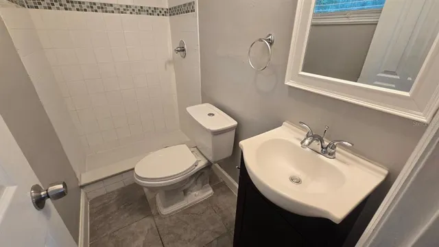 a white toilet sitting next to a bathroom sink