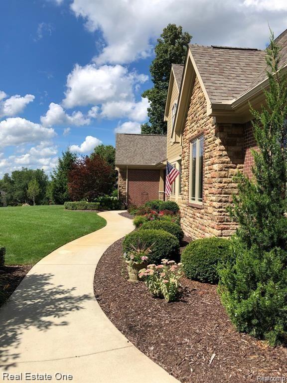 9091 Northpointe Ridge Brighton, MI 48114 - Photo 7 of 56 Winding walkway to your front door.