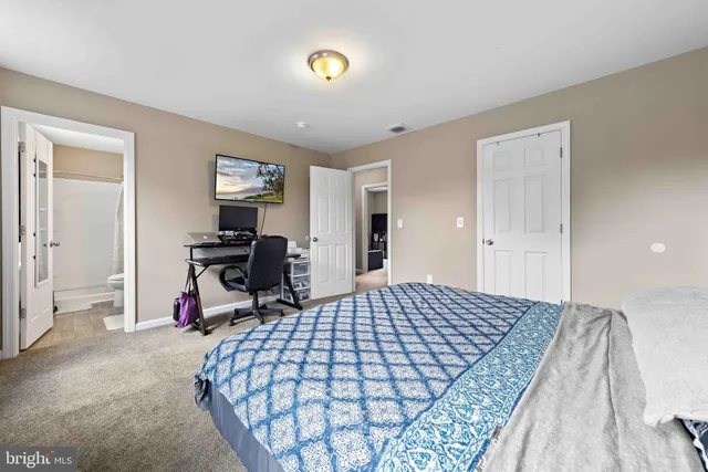 a bedroom with a bed and a table in it