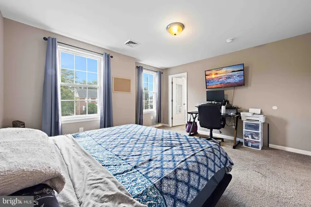 a bedroom with a bed and a desk