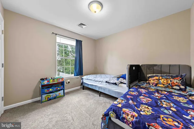 a bedroom with bed and a window