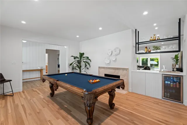 a large white bed in a room and a flat tv screen