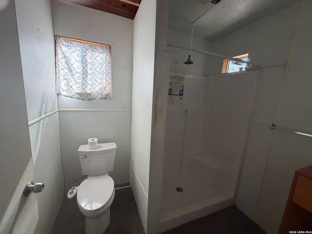 a white toilet sitting next to a bathroom sink