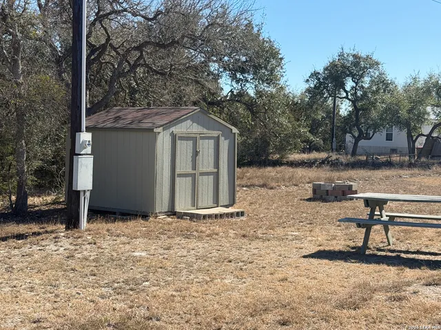 a backyard of a house with table and chairs