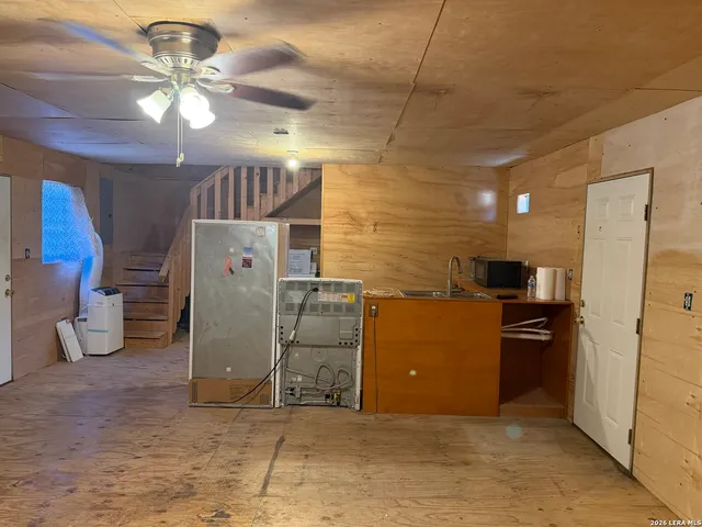 a kitchen with refrigerator and cabinets