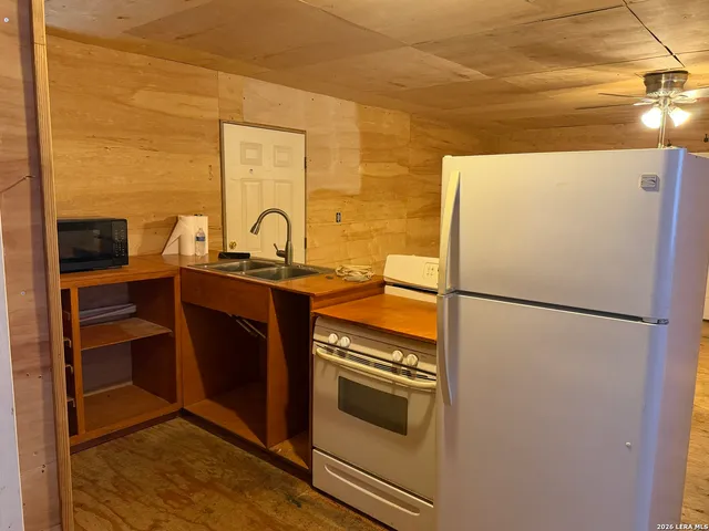 a kitchen with stainless steel appliances a refrigerator sink and stove