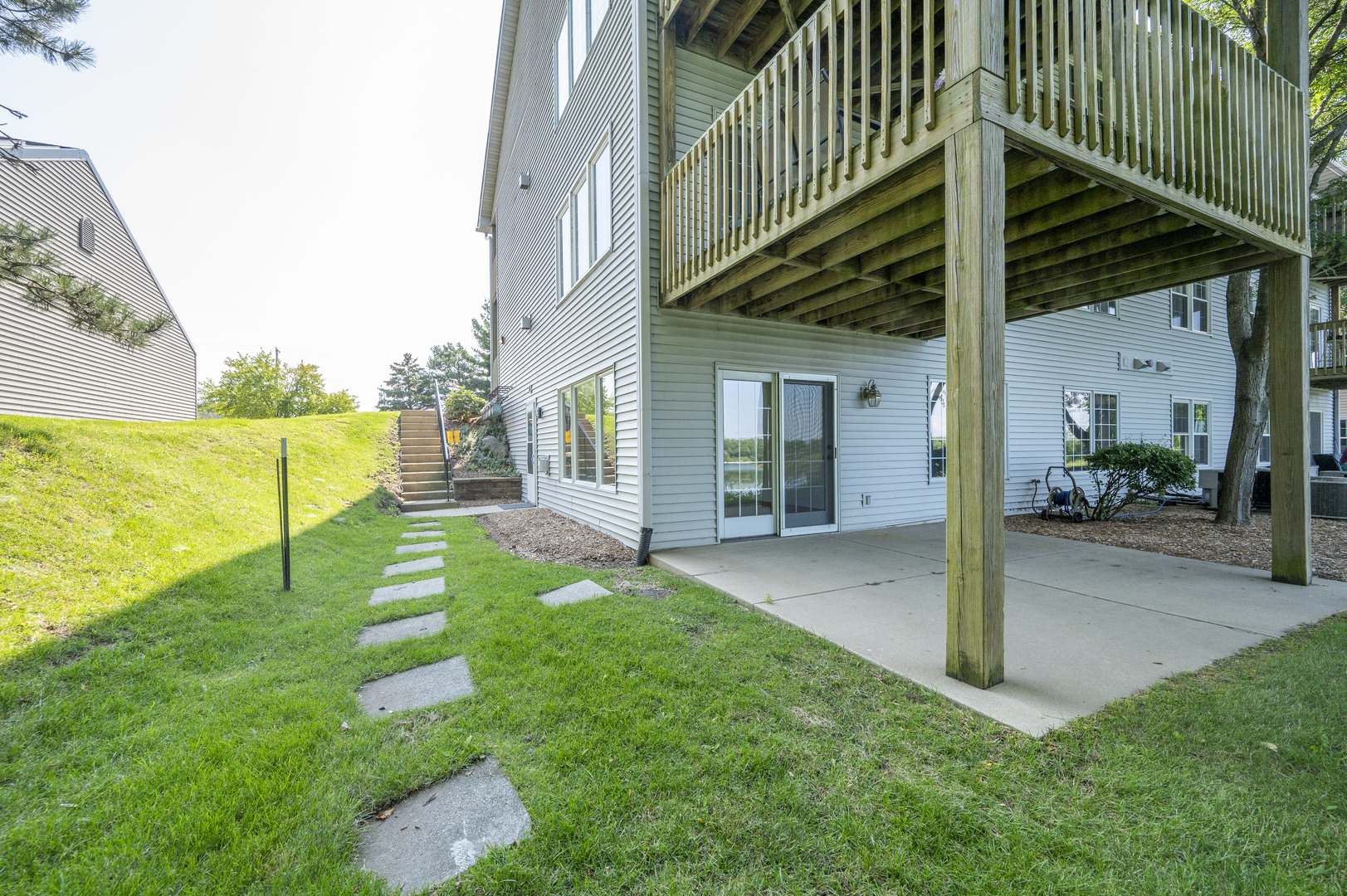 7280 North Alpine Road, Unit 4 Loves Park, IL 61111 - Photo 4 of 17 a view of a house with a yard and deck