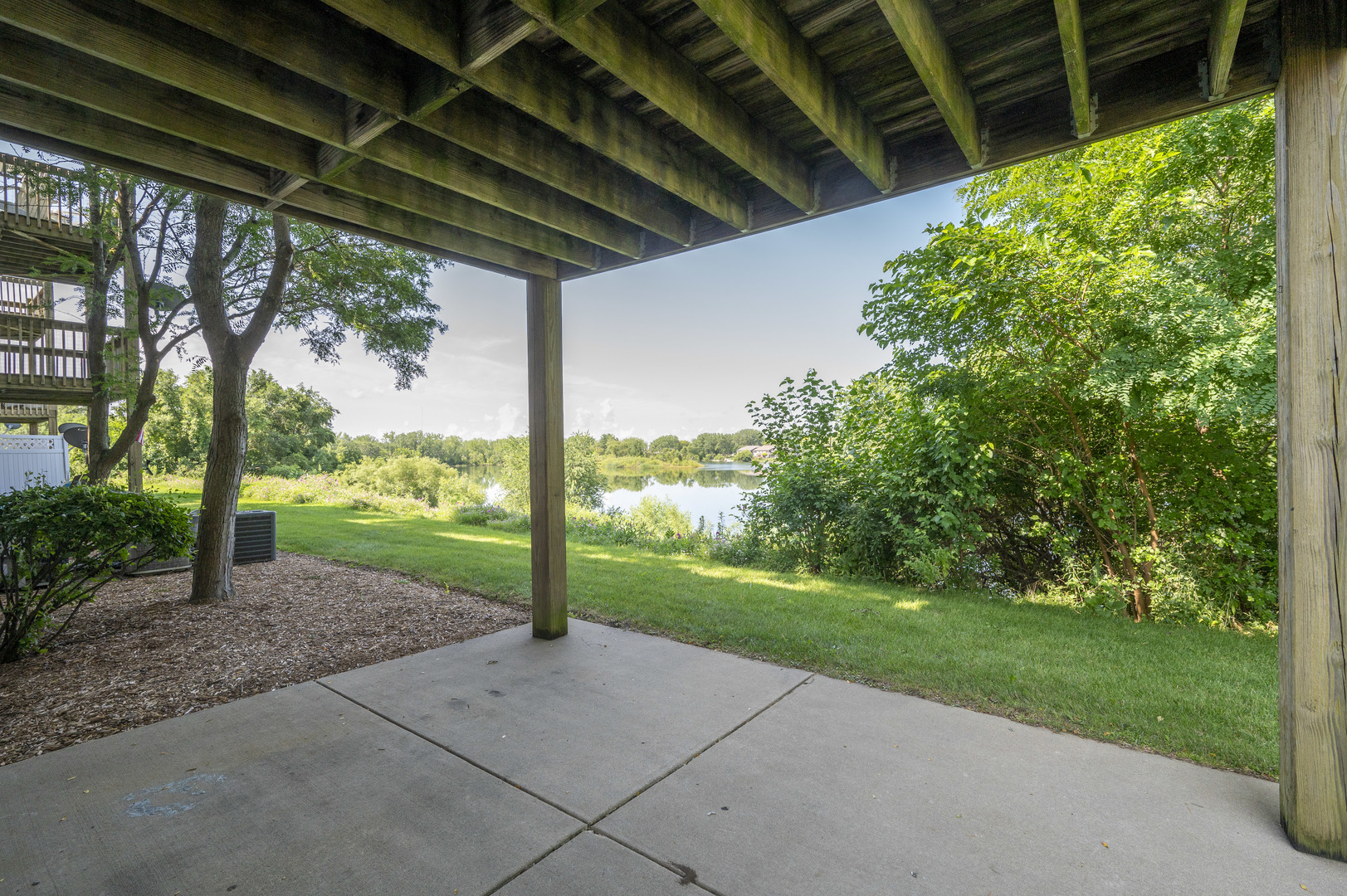 7280 North Alpine Road, Unit 4 Loves Park, IL 61111 - Photo 5 of 17 a view of a backyard with porch