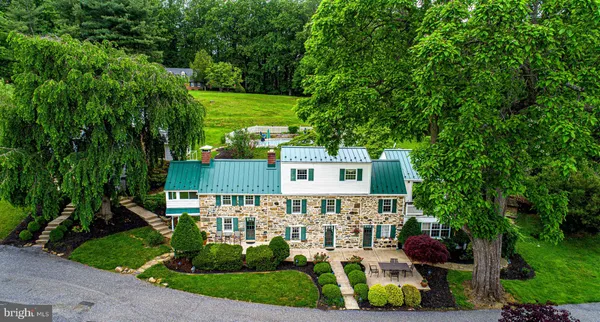 a view of a house with a yard and potted plants
