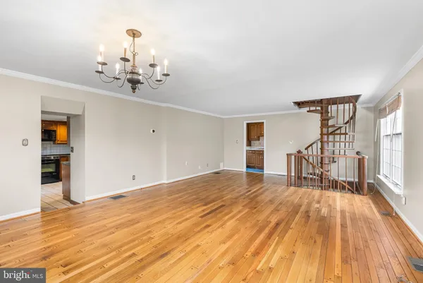 a view of empty room with wooden floor and fireplace