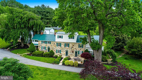a view of a house with a yard and sitting area