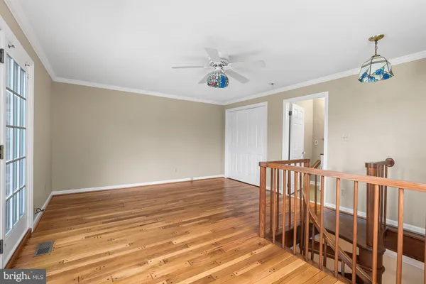 a view of an empty room with a window and a fan