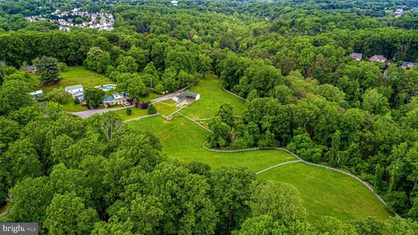 a view of a white house with a yard and fence