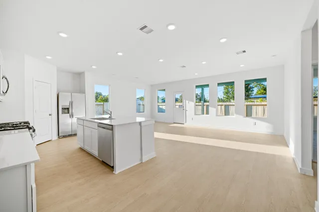a large white kitchen with a large window