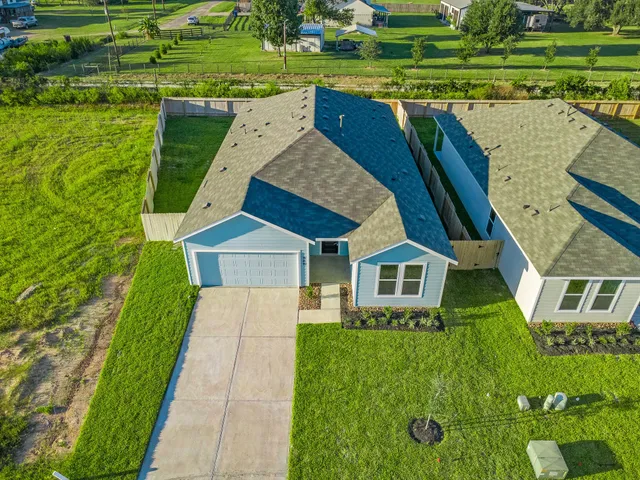 a front view of a house with a yard table and chairs