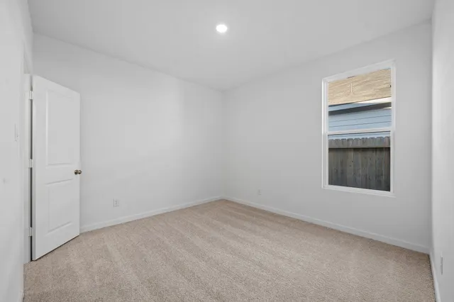 a view of an empty room and a window