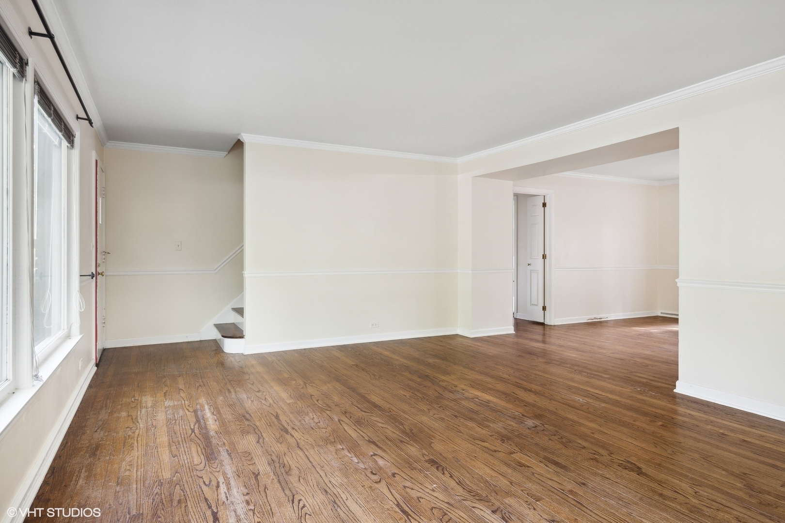 3117 Sprucewood Road Wilmette, IL 60091 - Photo 3 of 16 a view of an empty room with wooden floor and a window