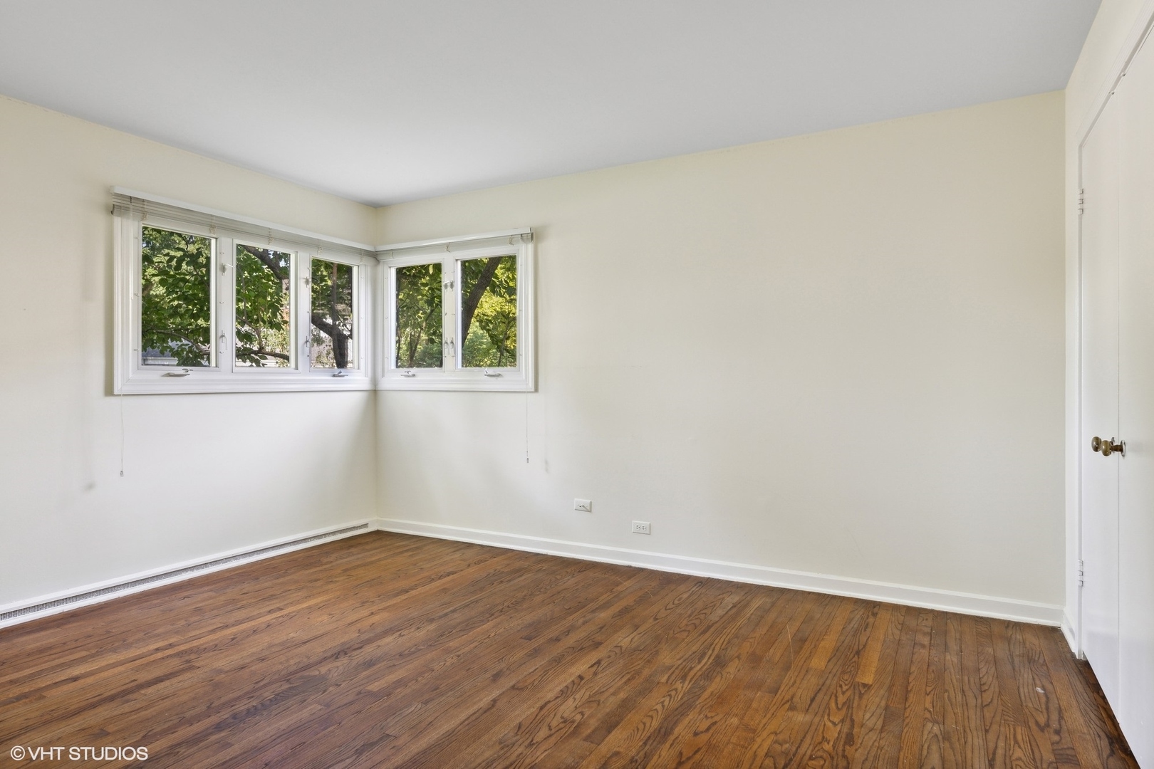3117 Sprucewood Road Wilmette, IL 60091 - Photo 7 of 16 wooden floor in an empty room with a window