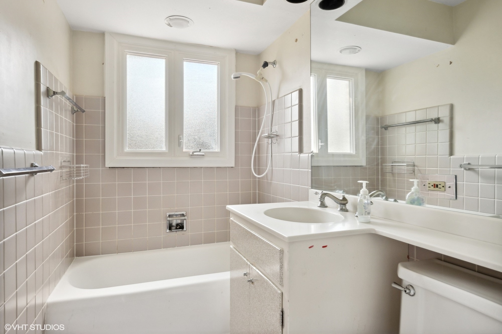 3117 Sprucewood Road Wilmette, IL 60091 - Photo 8 of 16 a bathroom with a sink tub vanity and a mirror