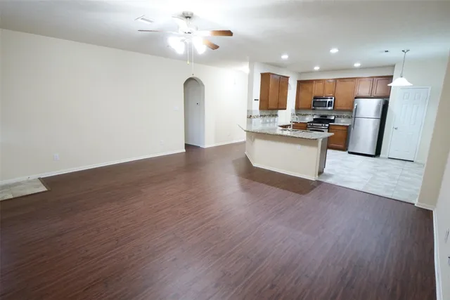 a view of kitchen with refrigerator microwave and stove