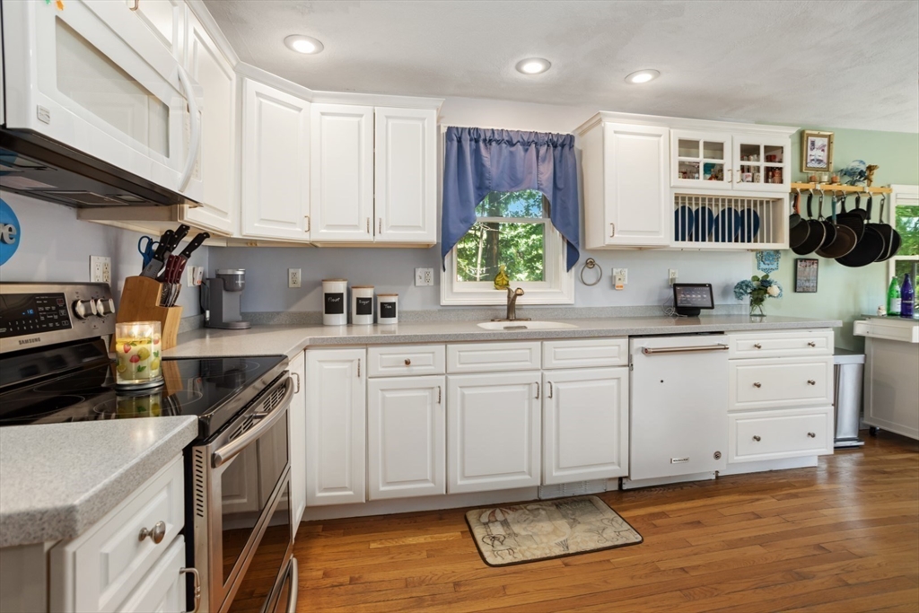 2 Allen Road Billerica, MA 01821 - Photo 11 of 32 a kitchen with cabinets stainless steel appliances a sink and wooden floor