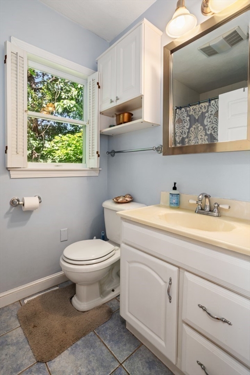 2 Allen Road Billerica, MA 01821 - Photo 20 of 32 a bathroom with a toilet sink and mirror