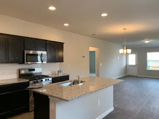 a living room with granite countertop furniture and a flat screen tv