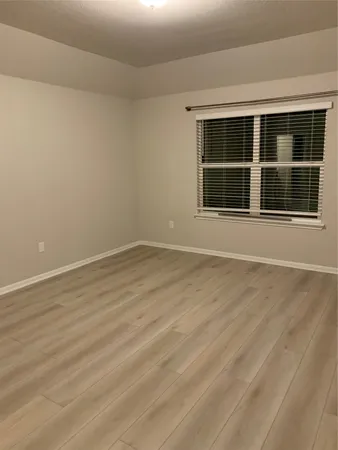 a kitchen with stainless steel appliances granite countertop a sink dishwasher a stove and a refrigerator with wooden floor