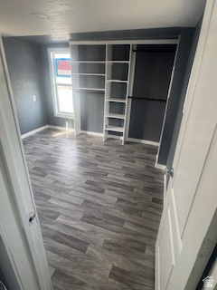 8155 South Redwood Road, Unit 96 West Jordan, UT 84088 - Photo 11 of 17 Unfurnished bedroom with dark wood-style floors and baseboards