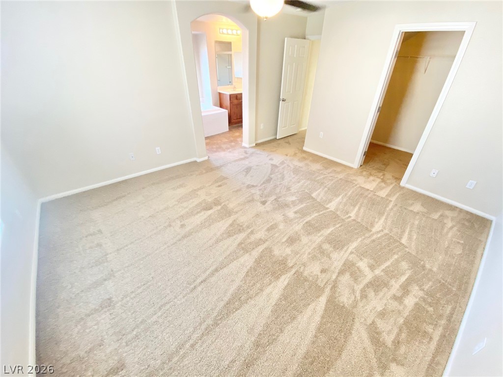 8569 Rhamus Court Las Vegas, NV 89149 - Photo 26 of 35 A spacious bedroom provides a blank canvas, offering versatility and comfort.