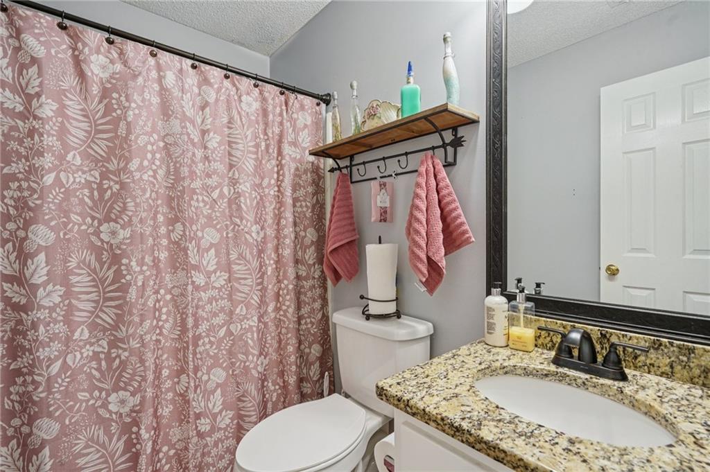 4496 Jackam Ridge Court Lithonia, GA 30038 - Photo 17 of 24 a bathroom with a granite countertop sink and a mirror