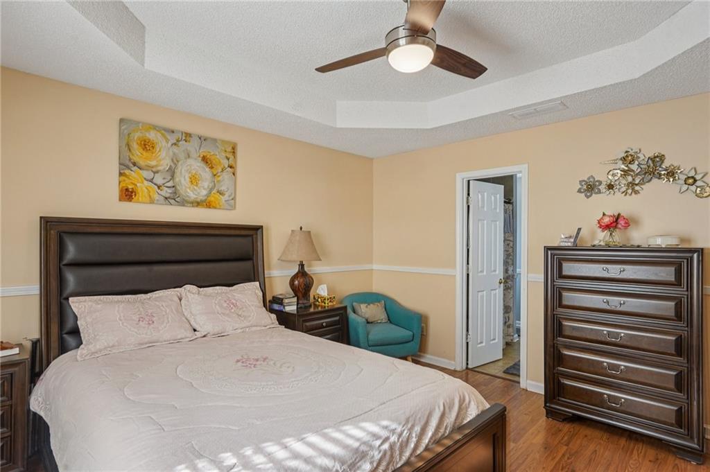 4496 Jackam Ridge Court Lithonia, GA 30038 - Photo 21 of 24 a bedroom with a bed and a chandelier